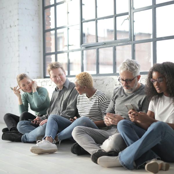 Diverse group of colleagues relaxing together in a modern, calm office space.