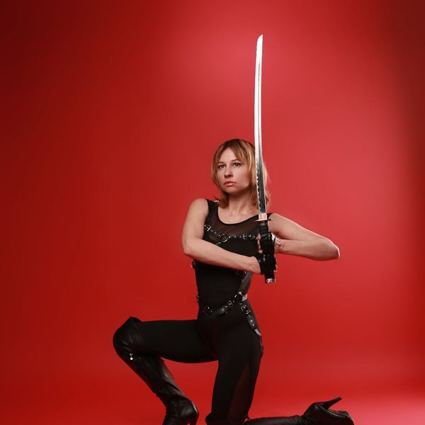 Person holding a powerful and dynamic yoga pose with a determined expression.